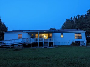 A single-story house with a front porch, a small deck, and a satellite dish. - No Say Left Farm (Cofield)
