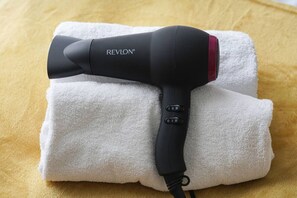A hair dryer with the brand REVLON placed on a folded white towel. - City Centre House • Sleeps 7 • Free Parking • Fast Wifi • Sky TV • Netflix • Self-Check-In • Yoko Property (Northampton)