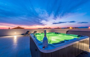 A rooftop pool area with a hot tub, lounge chairs, and a sunset view. - Awesome home in Zadar (Zadar)