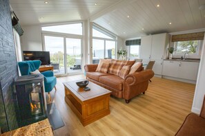 Relax in this inviting space with a comfortable sofa, flat-screen TV, and cozy fireplace.