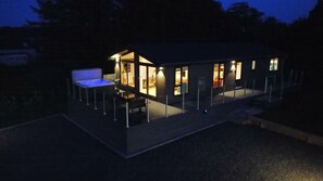 Relax on the spacious deck with a hot tub and seating area.