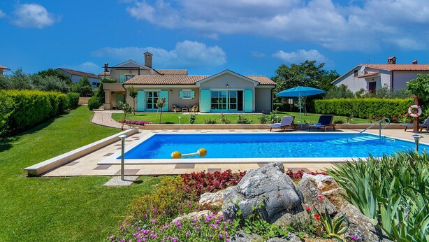 A residential property with a swimming pool, a well-maintained garden, and a two-story house with a tiled roof. - Beautiful home in Tar (Tar)