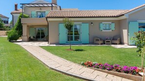 A two-story house with a tiled roof, a small front garden, and a paved walkway. - Beautiful home in Tar (Tar)