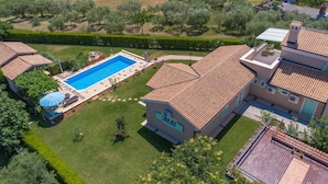 A residential property with a swimming pool, a well-maintained lawn, and a tiled roof. - Beautiful home in Tar (Tar)