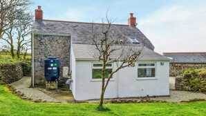 A house with a stone exterior, a small white building attached, and a tree in the foreground. - 2 bedroom accommodation in Troon, near Camborne (Troon, near Camborne)