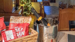 A room with a Christmas tree, a bottle of champagne, and bags of M&S mini shortbread trees. - 3 bedroom accommodation in Fir Tree, near Crook (Fir Tree, near Crook)