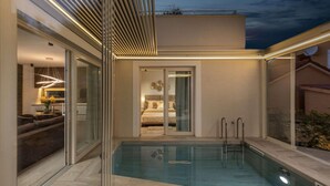 A modern pool area with a glass-enclosed bedroom and a dining area. - Gorgeous home in Nin with sauna (Nin)