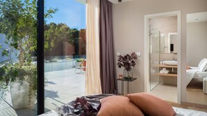 A modern hotel room with a large glass door leading to a balcony, a private bathroom, and a view of a swimming pool. - Lovely home in Pakostane (Pakostane)
