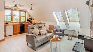 A modern loft with a kitchen, dining area, and seating space. - 2 bedroom accommodation in Foxhole, near Beauly (Foxhole, near Beauly)