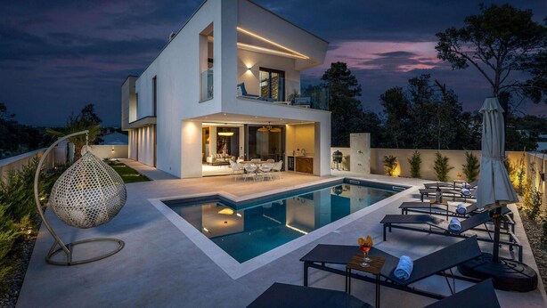 A modern two-story house with a swimming pool, outdoor seating, and a pergola. - Gorgeous home in Petrcane (Petrcane)