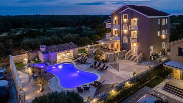 A multi-story building with a swimming pool, outdoor seating, and a landscaped garden. - 8 bedroom beautiful home in Zaton (Zaton)