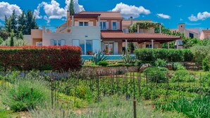 A large, multi-story house with a swimming pool, surrounded by lush greenery and a stone wall. - Beautiful home in Mirca (Mirca)