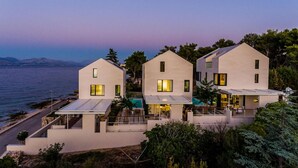 A modern coastal property with three connected buildings, a pool, and a view of the sea. - Stunning home in Sutivan with sauna (Sutivan)