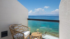 A balcony with a wicker chair and a small table, overlooking a clear blue sea and distant mountains. - Stunning home in Sutivan with sauna (Sutivan)