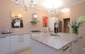 Enjoy cooking in this well-equipped kitchen with a central island, gas stove, and ample cabinetry.