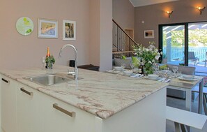 Enjoy a meal for two in this kitchen, which leads to a dining area with a scenic view.