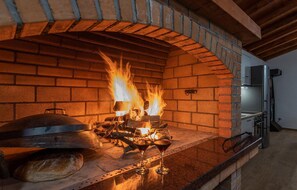 Enjoy authentic Italian cuisine in a rustic cooking environment, complete with a brick oven and modern kitchen amenities.