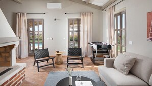 A cozy living room with a fireplace, a foosball table, and comfortable seating. - Amazing home in Sv. Lovrec (Sv. Lovrec)