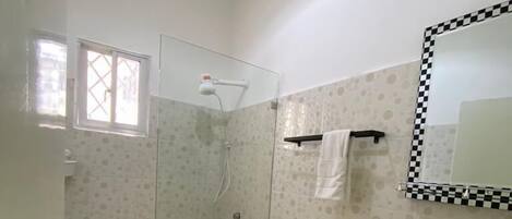 A bathroom with a toilet, sink, and shower.