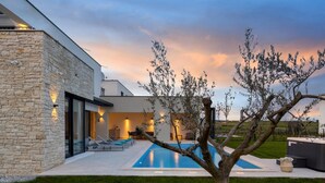A modern house with a swimming pool, outdoor seating, and a well-maintained lawn. - 4 bedroom gorgeous home in Brtonigla (Brtonigla)