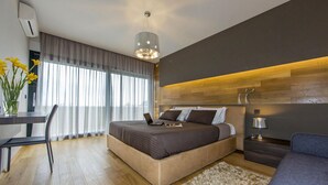A modern bedroom with a bed, desk, chair, and a large window with curtains. - Pet friendly home in Perini (Perini)
