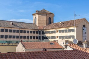 A building with a central tower, multiple windows, and a tiled roof.