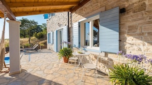 A stone building with blue shutters, a pool, and outdoor seating. - Villa Mariva (Carro d'oro) (Vrana)