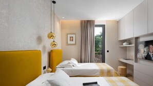 A modern hotel room with two beds, a television, and a balcony with curtains. - Awesome home in Zadar (Zadar)