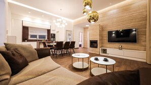 A modern living room with a sofa, coffee table, and TV.