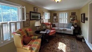 A living room with a sofa, armchair, and a coffee table. - Charming 3 bedroom home  (Lewisburg)