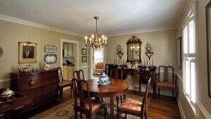 A dining room with a chandelier, wooden furniture, and a rug. - Charming 3 bedroom home  (Lewisburg)