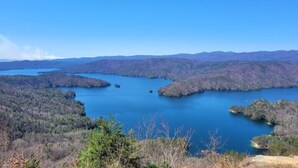 A lake surrounded by forested hills.