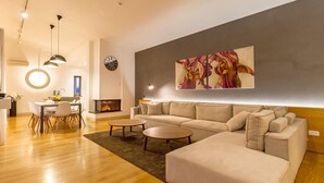 A modern living room with a sofa, coffee table, and dining area. - 5 bedroom gorgeous home in Hvar (Hvar)