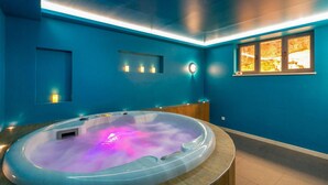 A spa room with a hot tub, blue walls, and a window with a view. - 5 bedroom gorgeous home in Hvar (Hvar)