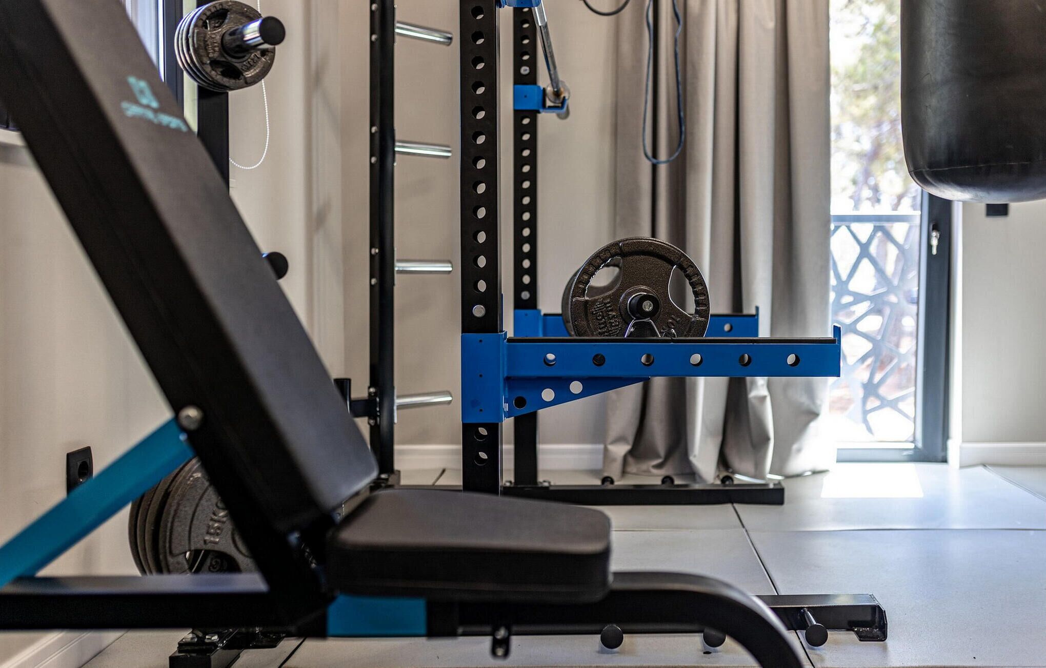 A gym with exercise equipment, including a bench and weight plates.