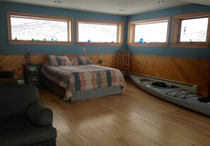 Relax in this serene retreat with a large bed, canoe storage, and a cozy seating area.