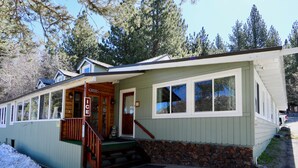 A small, single-story building with a porch and a staircase leading to the entrance. - Big Rock Resort (June Lake)