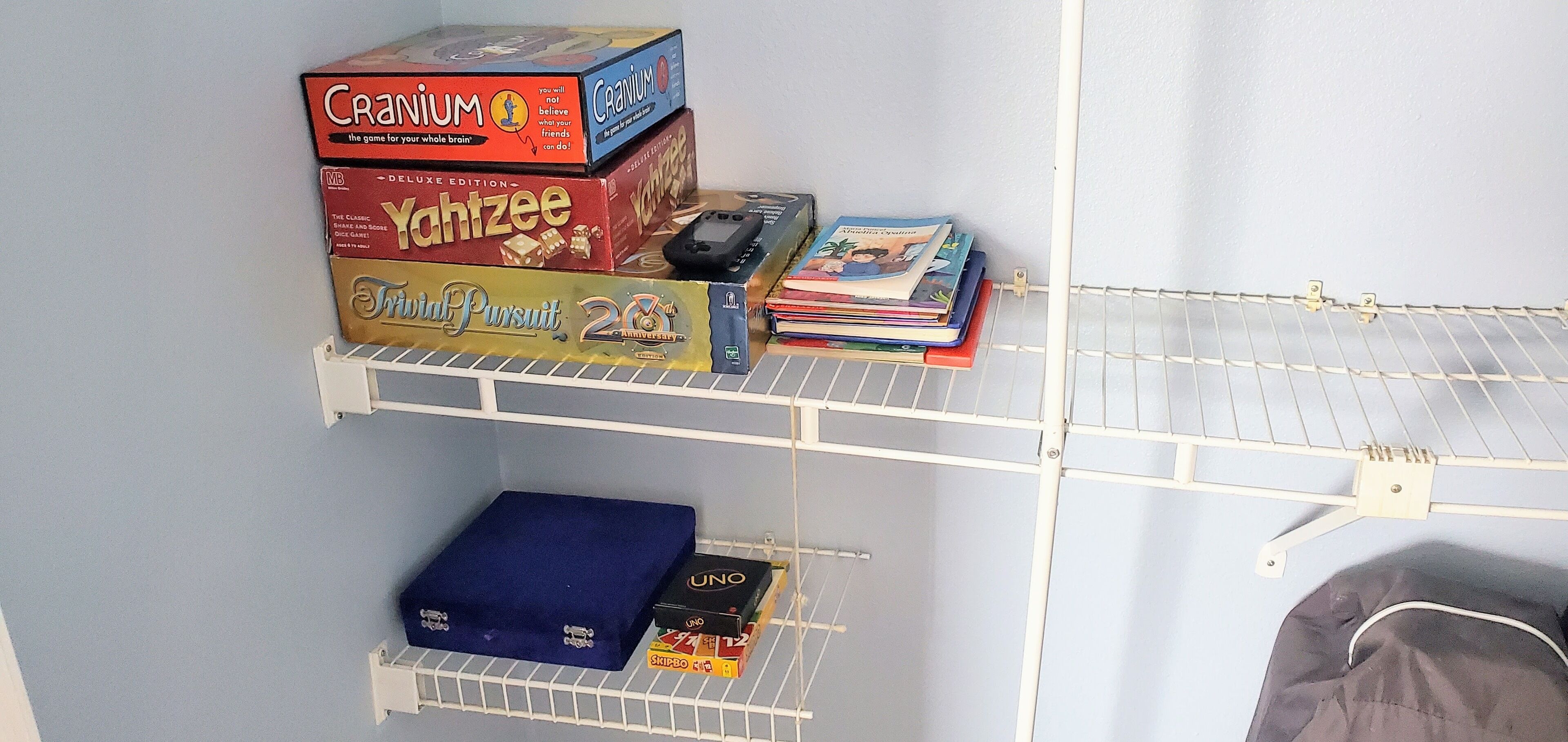 A shelf with board games and books.