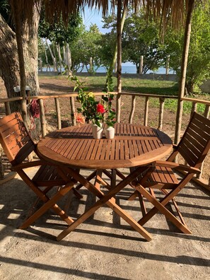 Sit and enjoy the serene view from this outdoor seating area with a round table and four chairs.