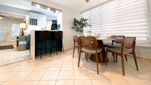 A modern kitchen with a dining area.
