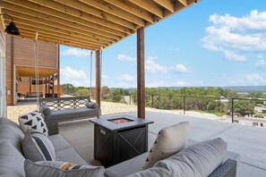 An outdoor patio with a wooden pergola, a fire pit table, and a sofa with cushions. - Private Hot Tub & Deck with Best Table Rock Views + $400 Free Tickets (Kimberling City)