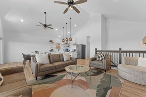 A spacious living room with a sofa, armchairs, a coffee table, and a ceiling fan. - Private Hot Tub & Deck with Best Table Rock Views + $400 Free Tickets (Kimberling City)