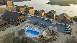 A resort with a swimming pool, guest rooms, and a view of a lake. - Ozarks View with Cornhole, Pickleball, Community Pools, Firepit,  Free Tickets and More (Kimberling City)