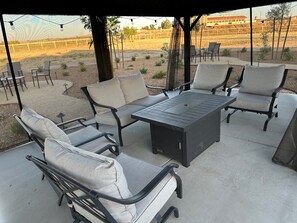 Relax in style with comfortable lounge chairs and a convenient table with power outlet.