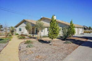 Welcome to a charming single-story home with a beautifully maintained front yard and paved driveway.