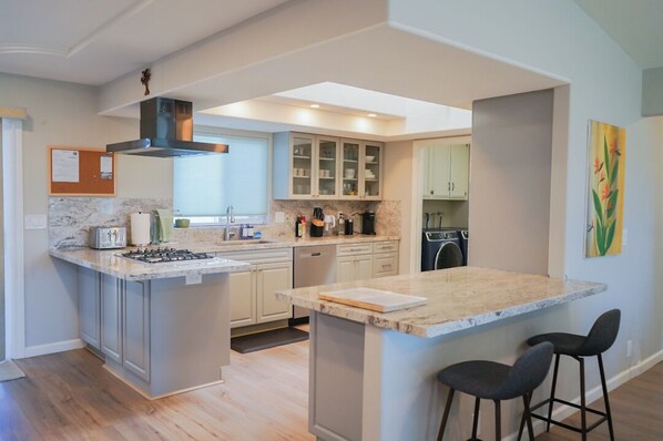 Enjoy cooking in this well-equipped kitchen with a central island, gas stove, and ample counter space.
