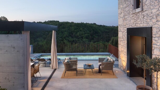 A rooftop terrace with a pool, outdoor seating, and a stone building. - Cozy home in Labin with WiFi (Labin)