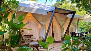 A tent with a covered patio area, a table, and chairs. - Playa La Caleta Bataan (Morong)