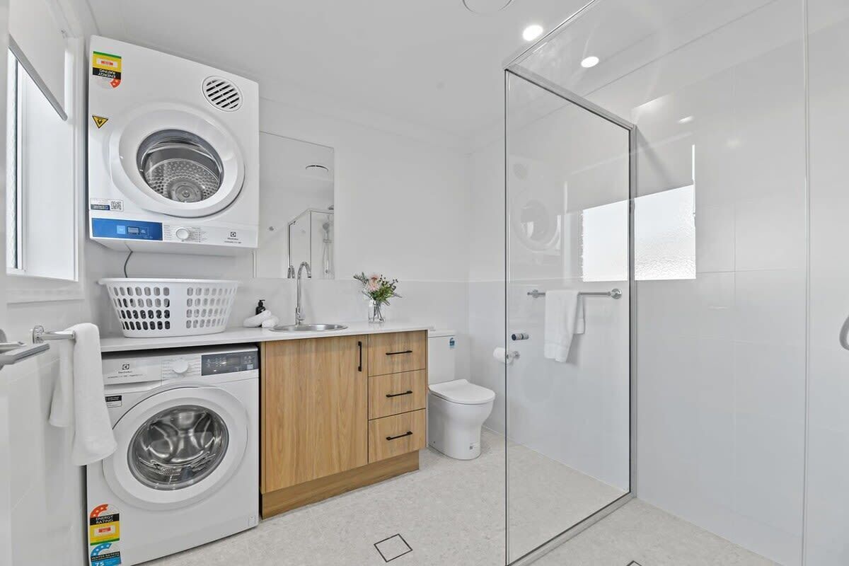 Bathtub, hair dryer, towels, shampoo