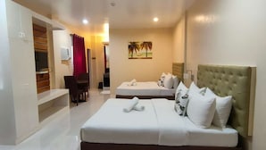 A hotel room with a bed, a desk, and a chair.